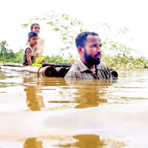 A father searches for food on a raft with two children