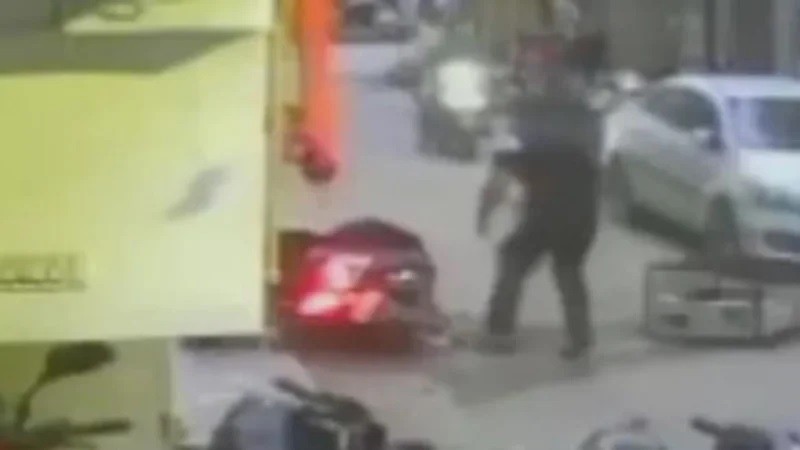 The young man was talking with his friend under the building when the AC broke on his head